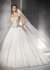 A magnificent wedding dress with rhinestones on a corset