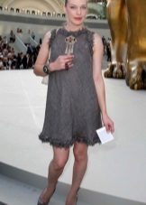 Milla Jovovich in a gray dress