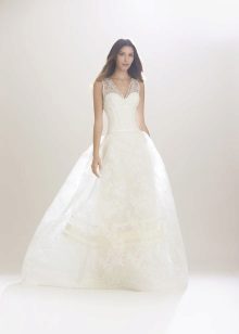 A puffy wedding dress with lace straps