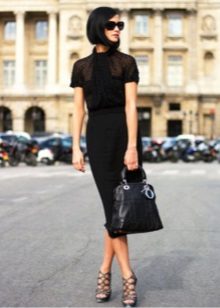 Office dress in black with a spacious top and a narrowed skirt to the bottom