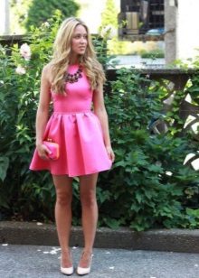 Różowa suknia wieczorowa z masywnym naszyjnikiem