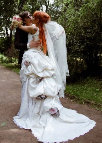 A magnificent wedding dress with a train and a tunic